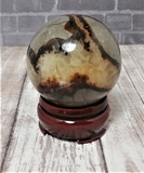 Gemstone Sphere Yellow Brown and Gray on Wood stand brick and woodgrain background GGandJ.com