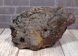 natural red and black stone covered in red crystals