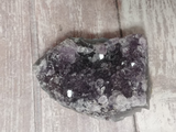 Purple Amethyst on Wood Grain Background