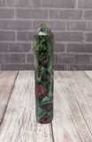 Ruby Fushite carved wand obelisk on brick and wood grain background