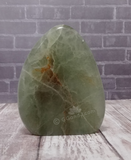 Natural green fluorite on brick and wood grain background
