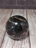 Rhodonite Ball from Madagascar on GGandJ.com Natural Pink and Black Gemstone Mineral Firework Explosion shape