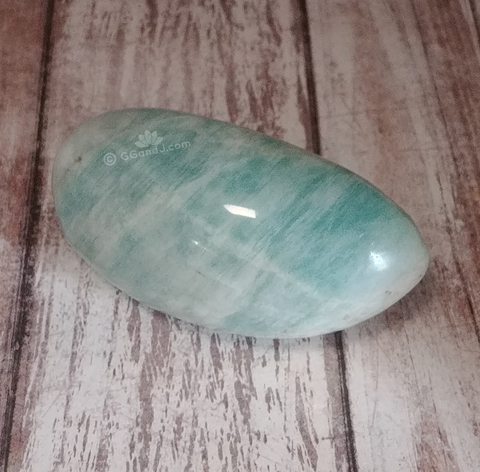 Amazonite gallet from Madagascar on wood grain background