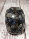 Iridescent gemstone on wood grain background Labradorite from Brazil GGandJ.com