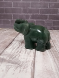 Aventurine elephant from India on brick and wood grain background