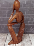Rear view of wooden person carving