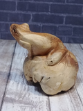 Side view of handcarved wood frog from Indonesia