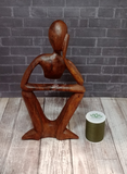 Abstract person statue with thread spool size reference
