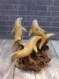 Three wooden dolphins on natural burl base on Gypsy Gems & Jewelry Naturally Unique