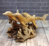 Three wooden dolphins on natural chinaberry tree mushroom knot