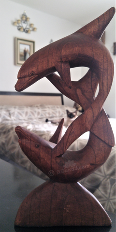 Wood dolphin decor statue from Indonesia in bedroom with Siamese Cat