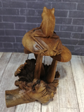 Rear view of wooden frog on mushroom