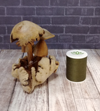 Mushroom statue with thread spool size reference