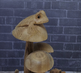 Close up of wood frog on mushroom statue
