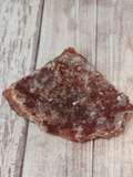 backside of hematite quartz, clear quartz with red veins