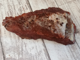 Bottom view of hematite quartz clear quartz covered in red