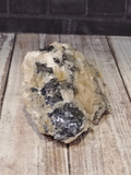 Calcite and Baryte on Galena with wood grain background