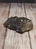 front view of pyrite on galena on wood grain background