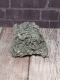 Prehnite mineral with wood grain and brick simple background