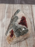 Wine colored Cobalto Calcite from Morocco on wood grain background