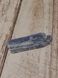 Kyanite on wood grain background