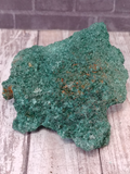green crystal on wood grain brick background