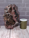 Hematite with Vanadinite next to thread spool size reference crystal gemstone sale