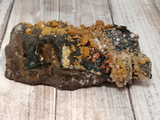 Natural orange crystals on black matrix